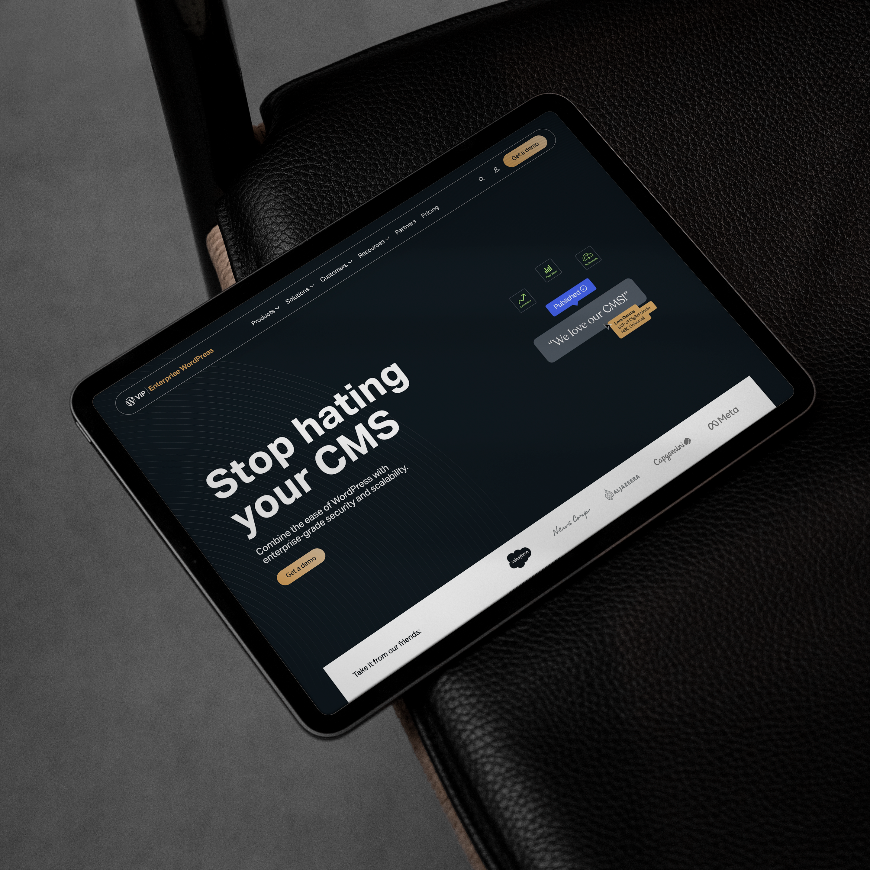 A tablet resting on a black leather surface displaying the WP Engine Enterprise WordPress website homepage, featuring the bold message “Stop hating your CMS” and showcasing a clean, dark-themed design interface.