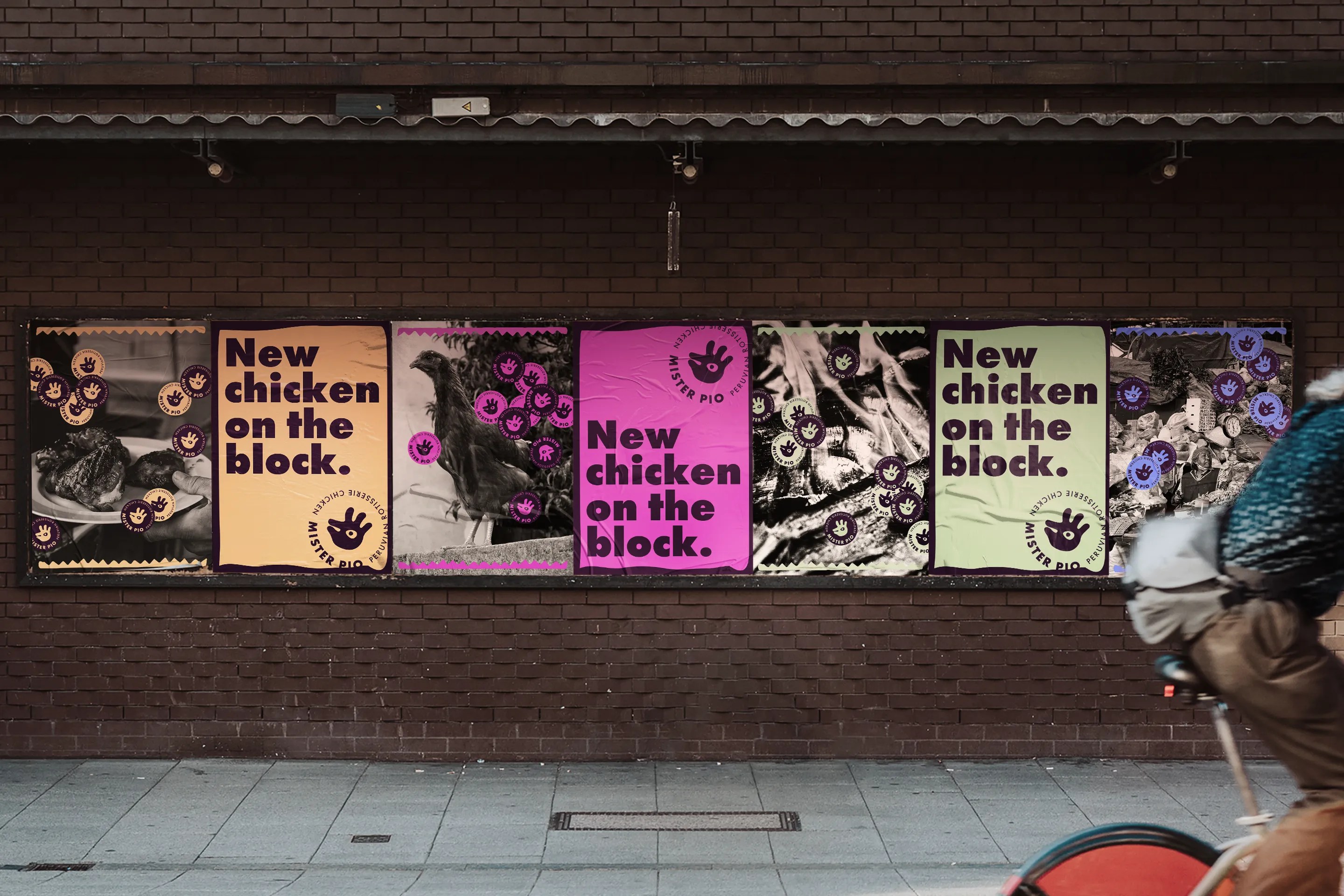 A row of colourful Mister Pio street posters against a brick wall. The posters say “New chicken on the block” with a mix of photography, branded graphics, and bold typography in pastel and neon colours.